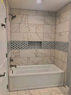 a bath tub sitting inside of a bathroom next to a shower head mounted on a wall