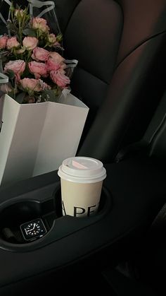 a coffee cup sitting in the center console of a car