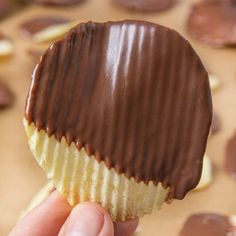 a hand holding a chocolate potato chip with the title above it that reads, chocolate potato chips perfect crunch combination of salty and sweet