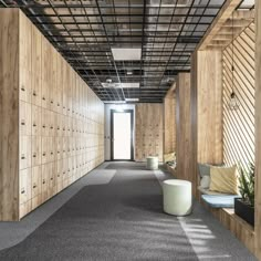 an empty hallway with wooden walls and benches