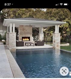 a pool with a fire place next to it