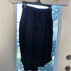 Zenana Elastic Waist Self Tie Tulip Hem Black Pockets Knee Length Casual/Office Skirt --Small: Length From Band To Hem- 24", Waist 24.5" --Medium: Length From Band To Hem- 24.5", Waist 25" --Large: Length From Band To Hem- 25", Waist 25.5" --Xl: Length From Band To Hem- 25.5", Waist 26" Black Stretch Skirt With Pockets, Black Elastic Waistband Midi Skirt, Versatile Black Midi Skirt, Versatile Black Mini Skirt, Black Midi Skirt With Elastic Waistband, Knee-length Black Skirt For Daywear, Black Summer Daywear Skirt, Black Knee-length Skirt For Day Out, Versatile Black Skirt For Day Out