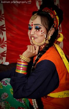 a woman with painted face and colorful jewelry