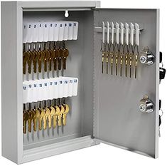 an open metal cabinet with keys and scissors in the door to each compartment, on white background