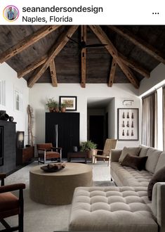 a living room filled with furniture and a flat screen tv on top of a wooden ceiling