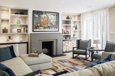 a living room with a couch, fireplace and bookshelves on the shelves above it