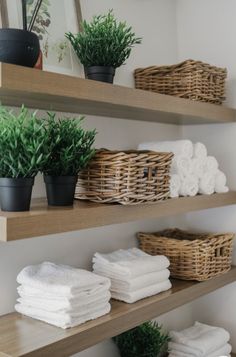 some shelves with towels and plants on them