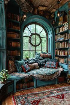 a room with bookshelves, windows and rugs on the floor in front of it