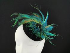 JCN Couture Fascinators - Fall / Winter Collection  Hand-blocked button fascinator in black fur felt and natural peacock sword feathers. Black Swaroski style beads in the centre. Finished with black satin trimming. The feathers are sewn, not glued! The fascinator is supported by an elastic band in the back.  I'm happy to send more information and pictures, please ask! Kindly add a contact phone number upon check-out, especially in case of priority shipping, it's required in the shipping documents. Couture Fascinators, Futuristic Mask, Evening Hat, Shipping Documents, Green Fascinator, Satin Noir, Cocktail Hat, Fall Winter Collection, Peacock Feathers