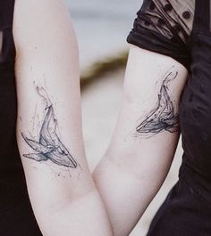 two women with matching tattoos on their arms