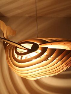 a wooden light fixture hanging from the ceiling