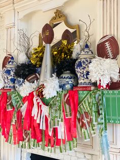 a mantel decorated with footballs, pom - poms and streamers