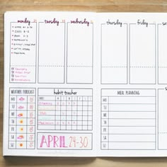 an open planner with the month numbers and dates on it, next to a pen