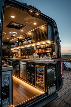 the back end of a truck with its door open and shelves full of drinks on it