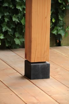 a wooden post sitting on top of a wooden floor