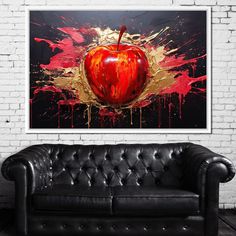 an apple is painted on the wall next to a black leather couch in front of a white brick wall