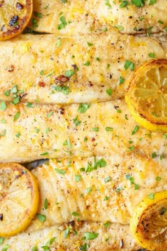 chicken with lemons and parsley on the side, ready to be cooked in the oven