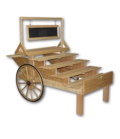 a wooden cart with wheels and a chalkboard attached to the top, sitting in front of a white background