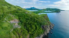 an aerial view of the ocean and mountains