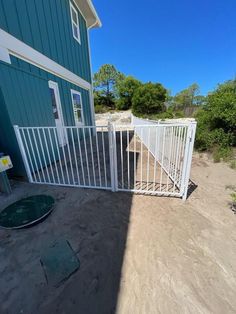 a house with a white gate next to it