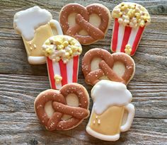 decorated cookies in the shape of heart shaped pretzels, popcorn, and beer