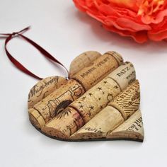 a heart shaped wine cork ornament sitting next to a flower