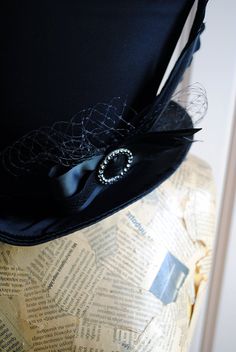 The Liza is a striking cabaret inspired full size top hat. It is covered with beautiful shiny black satin. It is decorated with black ribbon around the crown, black veil, half bow with black crystal buckle and two elegant black goose feathers. Also available as a medium size mini top hat: https://www.etsy.com/listing/256101614/victorian-witch-hatblack-mini-top?ref=shop_home_active_14 Need this TOP HAT in another color?Just send me a message to talk about a custom hat made just for you! This hat Fitted Wide Brim Top Hat For Halloween, Wide Brim Fitted Top Hat For Halloween, Vintage Top Hat With Curved Brim For Costume Party, Vintage Curved Brim Top Hat For Costume Party, Vintage High Crown Top Hat For Costume Party, Gothic Top Hat With High Crown For Parties, Gothic Top Hat With Short Brim For Halloween, Fitted Steampunk Top Hat For Halloween, Steampunk Fitted Top Hat For Halloween