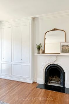 an empty living room with white walls and wood floors