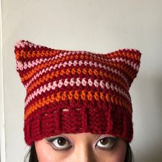 a woman wearing a knitted cat hat