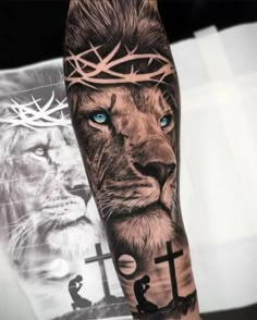 a man's arm with a lion and cross on it, in front of a photo