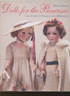 two dolls are standing next to each other in dresses and hats with fur stolers