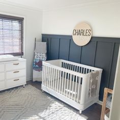 a baby's room with a crib, dresser and changing table in it