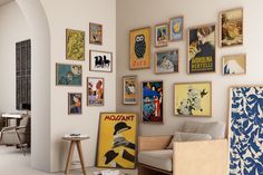 a living room filled with furniture and pictures on the wall