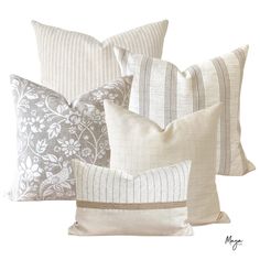 four pillows with different patterns on them, one is white and the other is gray