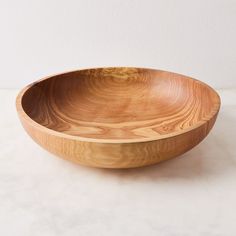 a wooden bowl sitting on top of a table