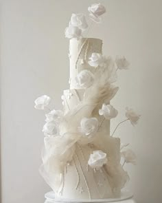 a white wedding cake with flowers on top