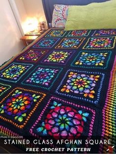 a colorful crocheted blanket on top of a bed