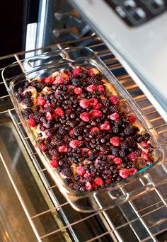 a casserole dish with berries in it sitting on an oven rack