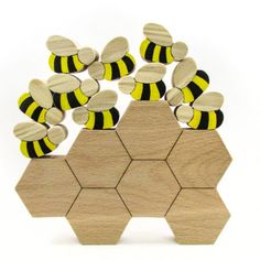 a wooden toy with bees on it and some honeycombs in the middle,