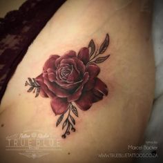 a woman's stomach with a rose tattoo on it