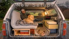 a man sitting in the back of a van with his dog