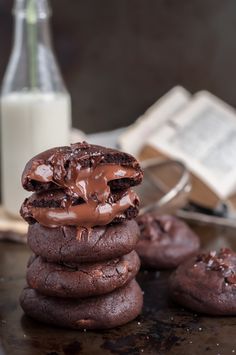 chocolate cookies stacked on top of each other next to a bottle of milk and a glass of milk