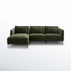 a green couch sitting on top of a white floor