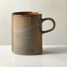 a coffee cup sitting on top of a white counter