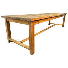 a wooden table with two legs and a long slab on one end, against a white background