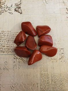 Red Jasper is gently stimulating and also an extremely protective stone.  It can neutralise radiation and other forms of environmental and electromagnetic pollution.  Red Jasper rectifies unjust situations and grounds energy.  Brings problems to light and provides insights into difficult situations.  An excellent "worry bead", Red Jasper calms the emotions.  Aids in dream recall.  Cleans and stabilises the aura.  A stone of health, Red Jasper strengthens and detoxifies the circulatory system, blood and liver. There are some inclusions and small dings in these stones, the price reflects this.  You will receive ONE Tumbled Jasper stone which will range from 1 inch to 1 1/2 inch in length. No two stones are alike, the photos show a sample. Your stone will be cleansed with the smoke of sage an Ares Offerings, Aries Mood, Crystals Witchcraft, Red Jasper Stone, Dream Recall, Witchcraft Supplies, Circulatory System, Jasper Stone, Holistic Healing