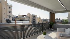 a balcony with white furniture and buildings in the background