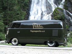 an old van parked in front of a waterfall with the word folbee written on it