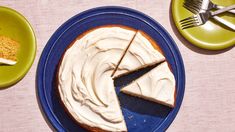 a piece of cake with white frosting on a blue plate