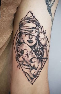 a black and white tattoo on the leg of a woman with an arrow in her hand